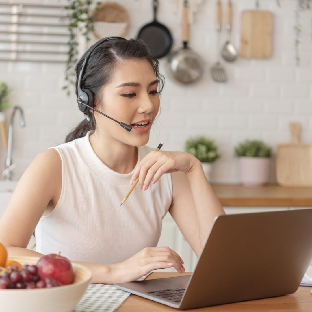 young Asian businesswoman using computer laptop talking for video call conference meeting. work from home concept.